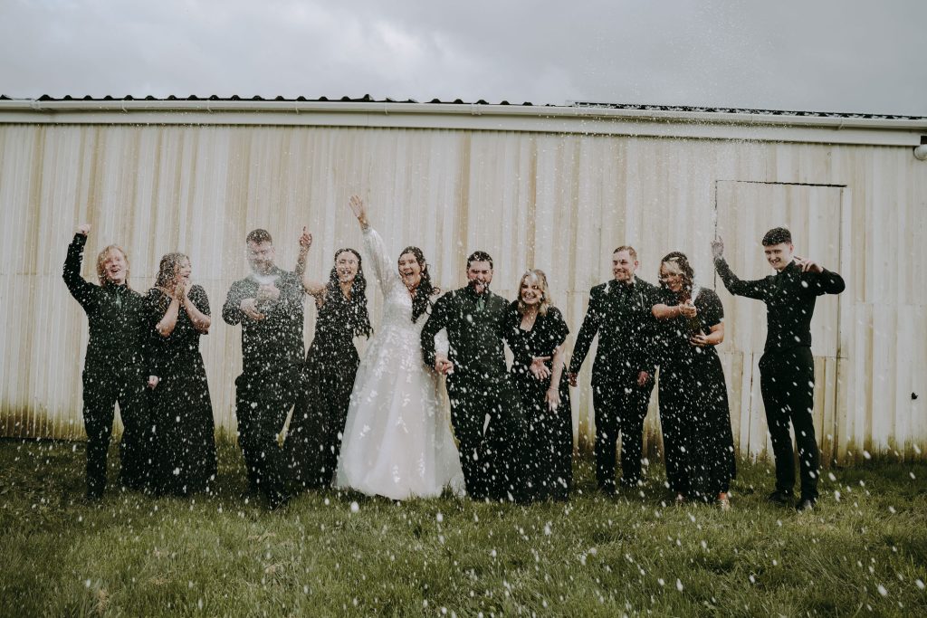 A champagne spray photographer captured by wedding photographer, Jordan Greenwood.